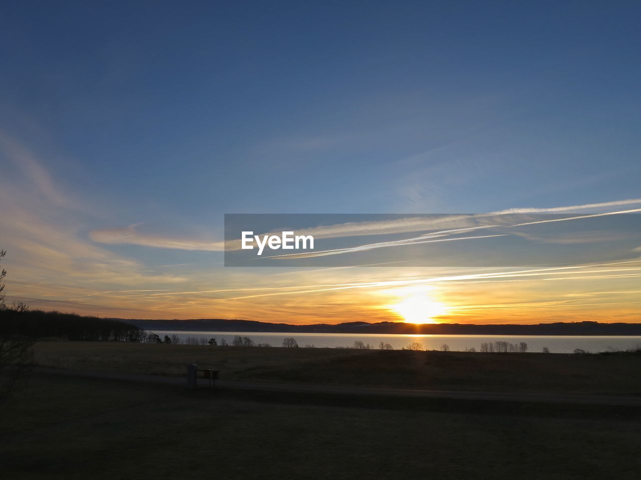 Scenic view of beach against sky during sunset