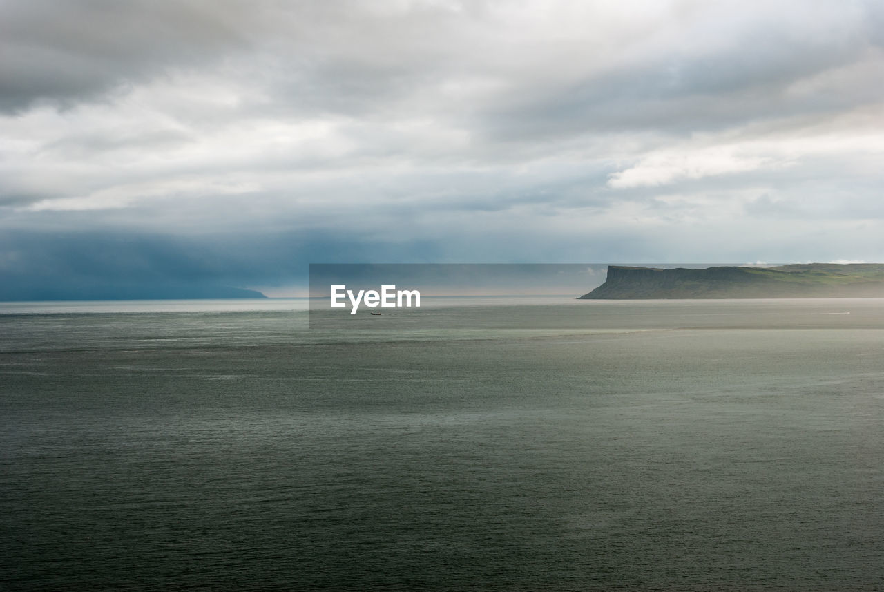 View of calm sea against clouds