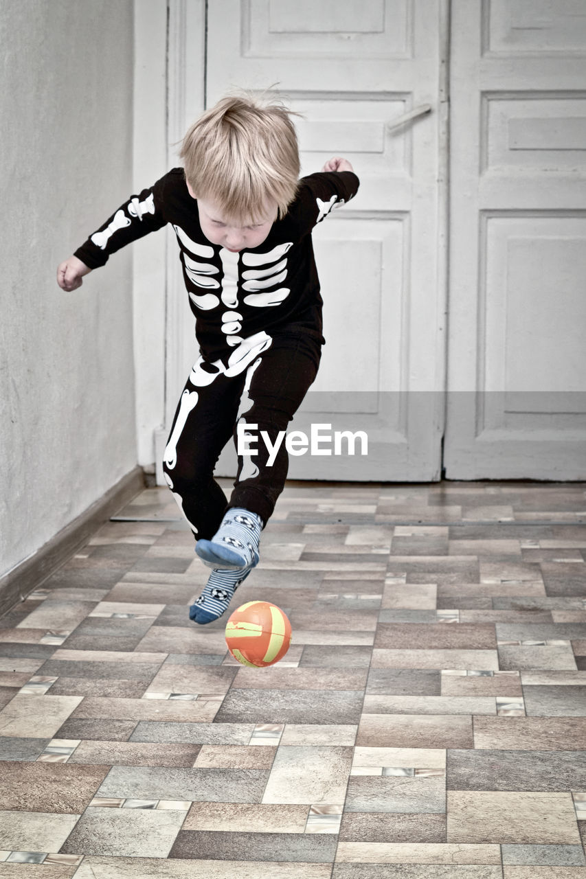 child, childhood, soccer, one person, full length, white, black, blond hair, sports, men, ball, motion, football, fun, casual clothing, toddler, spring, mid-air, lifestyles, leisure activity, architecture, sports equipment, jumping, clothing, female, soccer ball, day, person