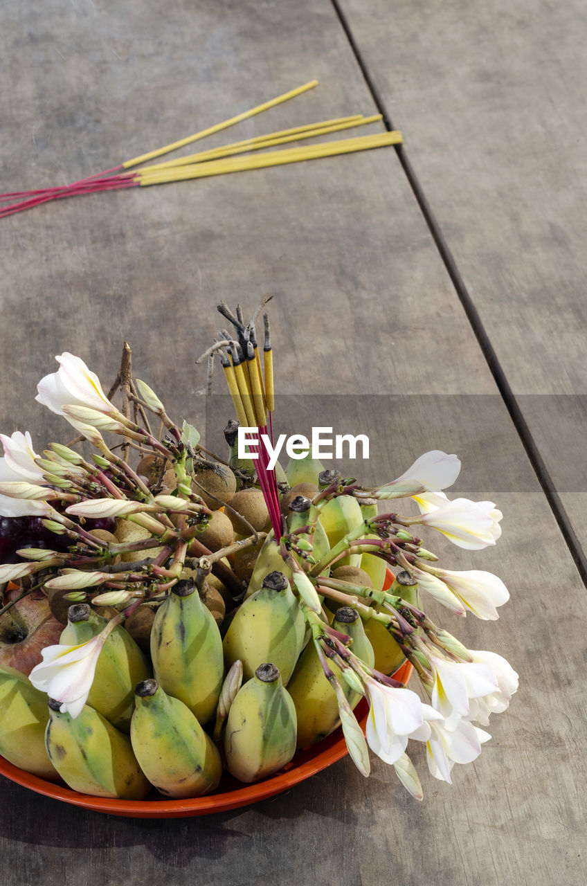 food and drink, flower, food, freshness, healthy eating, yellow, wellbeing, no people, produce, wood, floristry, nature, high angle view, plant, flowering plant, floral design, table, still life, vegetable, fruit, leaf, indoors