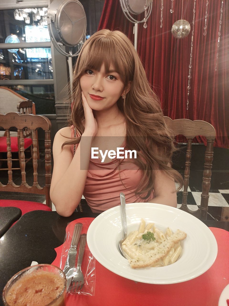 Portrait of young woman sitting at restaurant