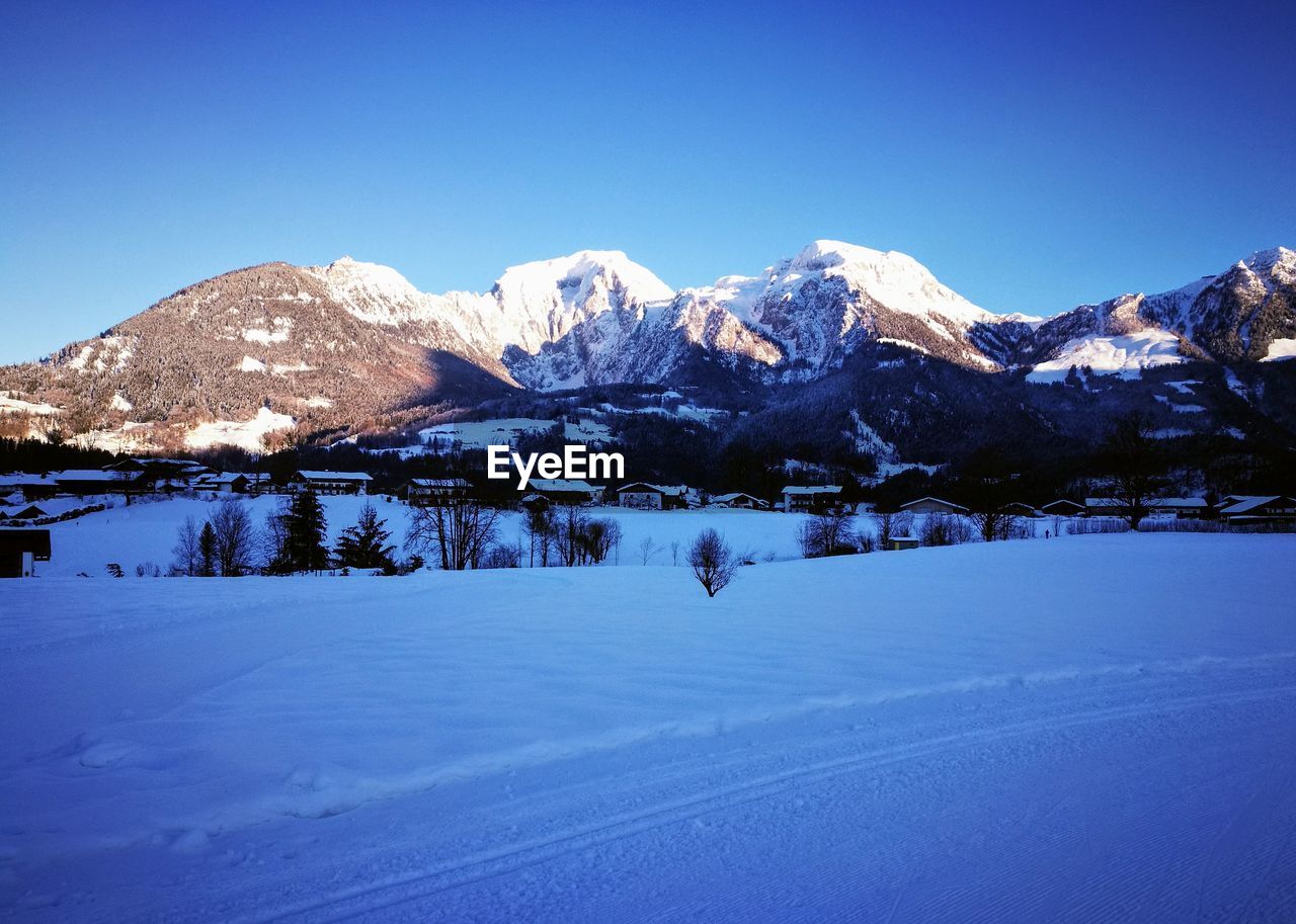 SNOWCAPPED MOUNTAINS AGAINST BLUE SKY