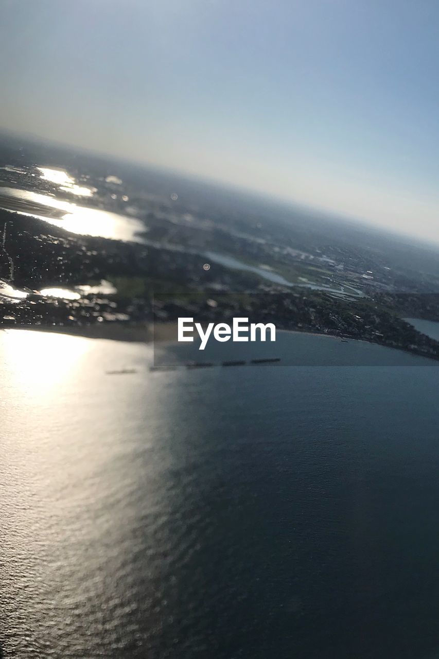 AERIAL VIEW OF CITY BY SEA AGAINST SKY