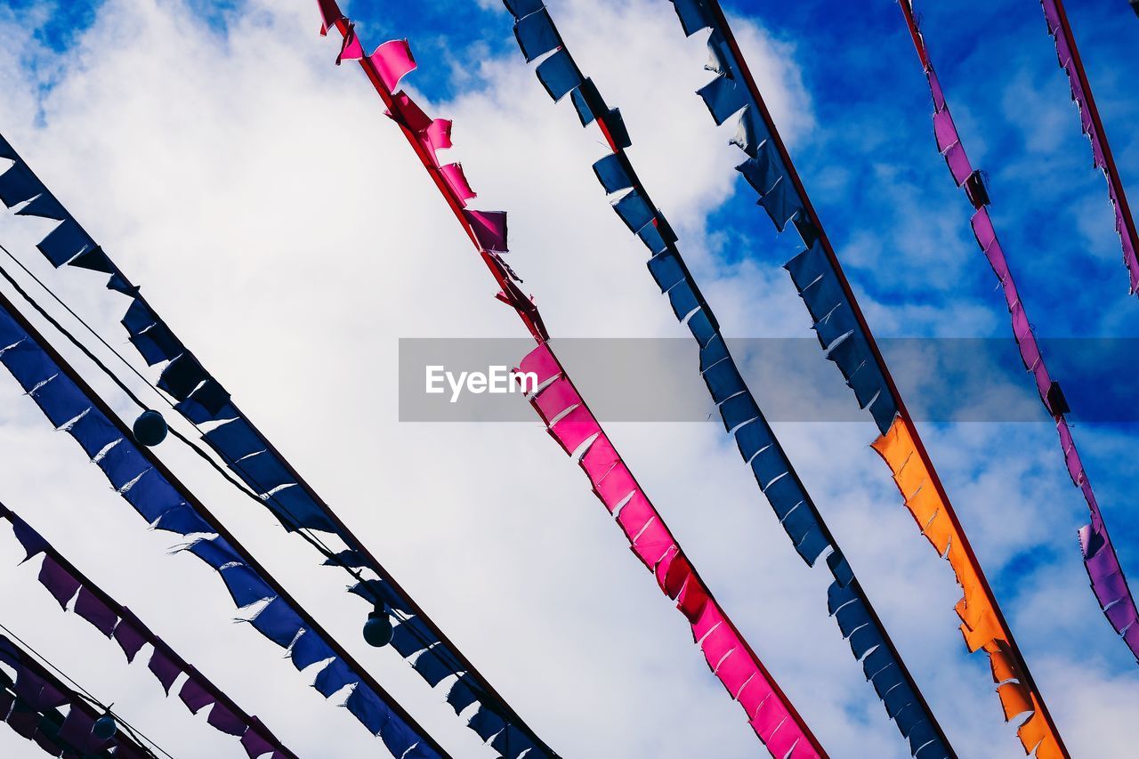 Low angle view of bunting against cloudy sky