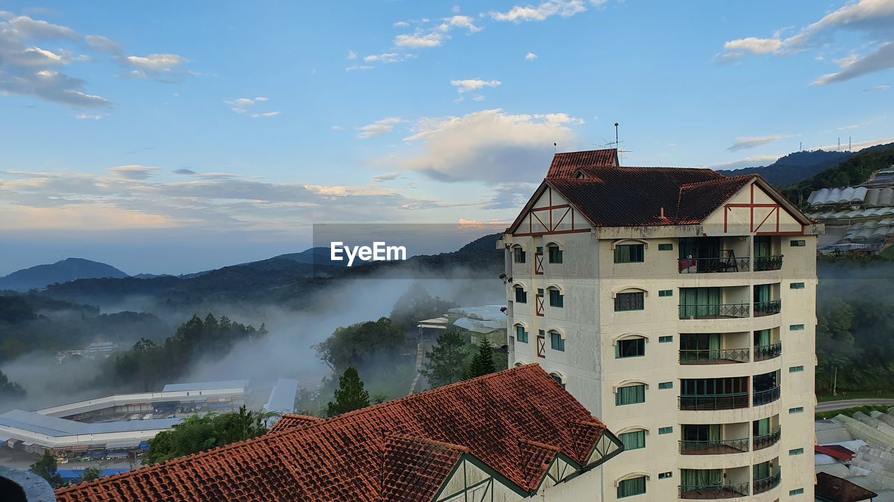 architecture, built structure, building exterior, building, house, sky, landscape, nature, environment, mountain, residential district, cloud, travel destinations, city, travel, roof, scenics - nature, fog, tourism, no people, land, beauty in nature, outdoors, water, high angle view, mountain range, rural scene, history, blue