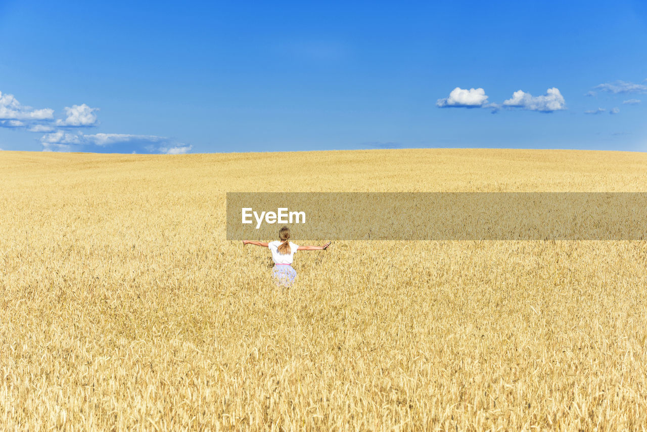 Full length of man standing on field against sky