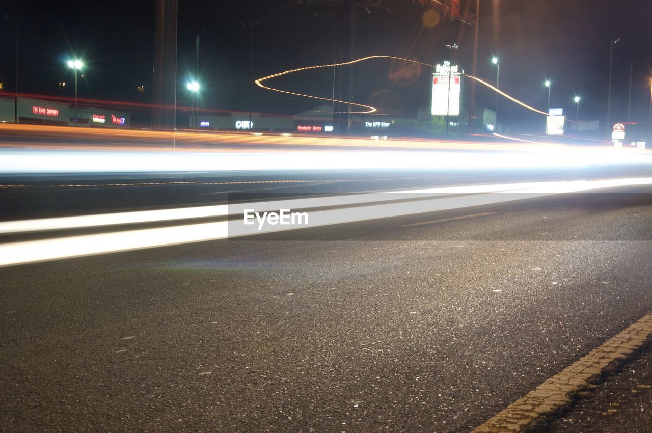 LIGHT TRAILS ON ROAD AT NIGHT