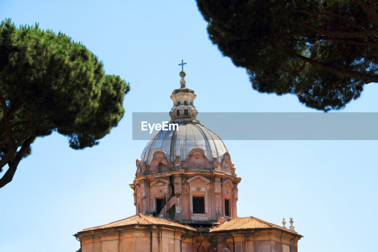 Low angle view of santi luca e martina against clear sky in city