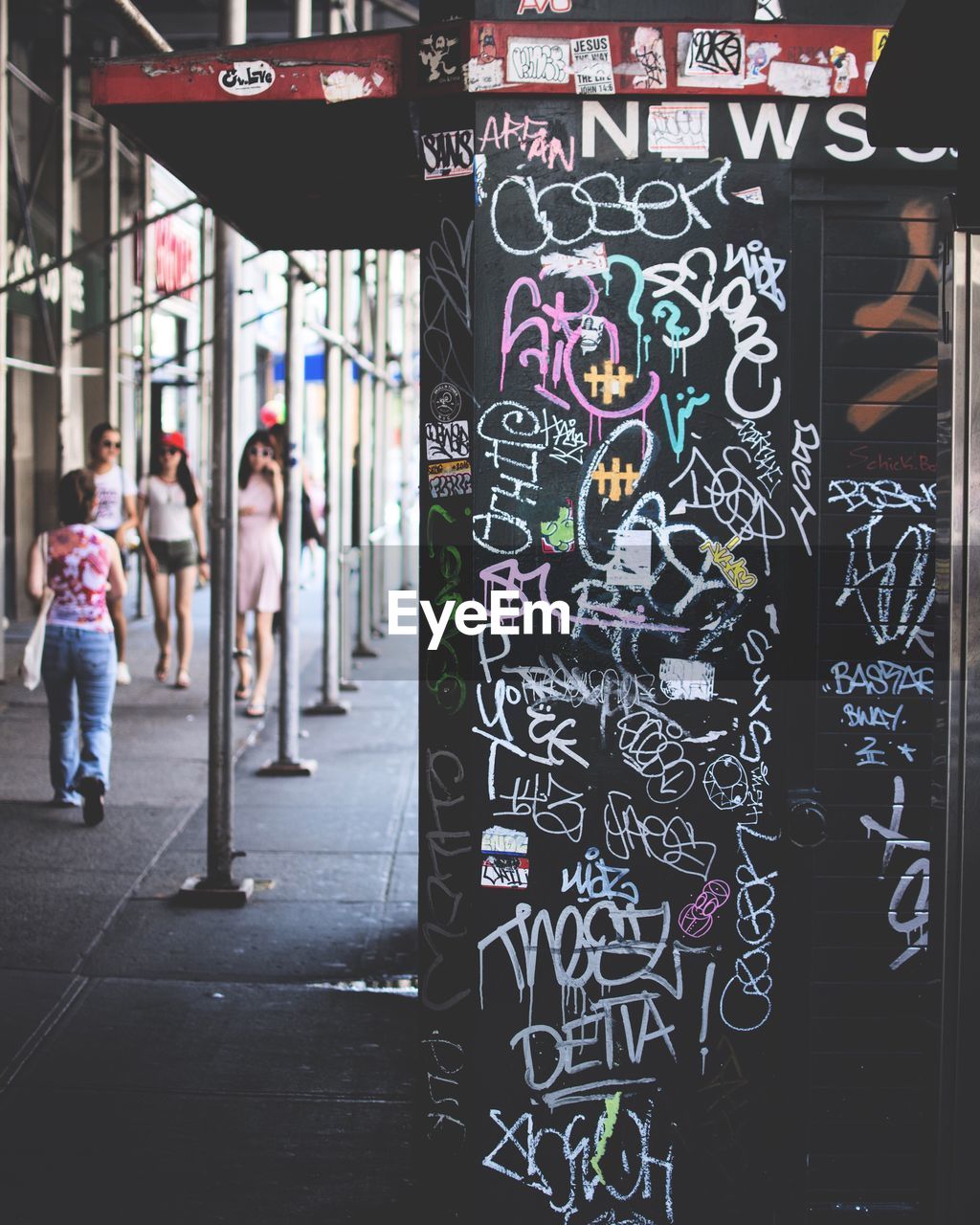 WOMAN IN GRAFFITI WALL