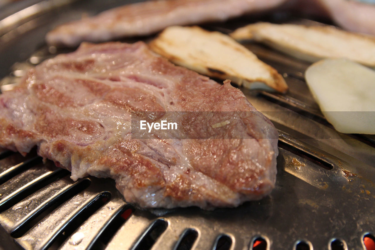 Korean grilled pork bbq or samgyeopsal-gui with charcoal at korean restaurant, busan, south korea