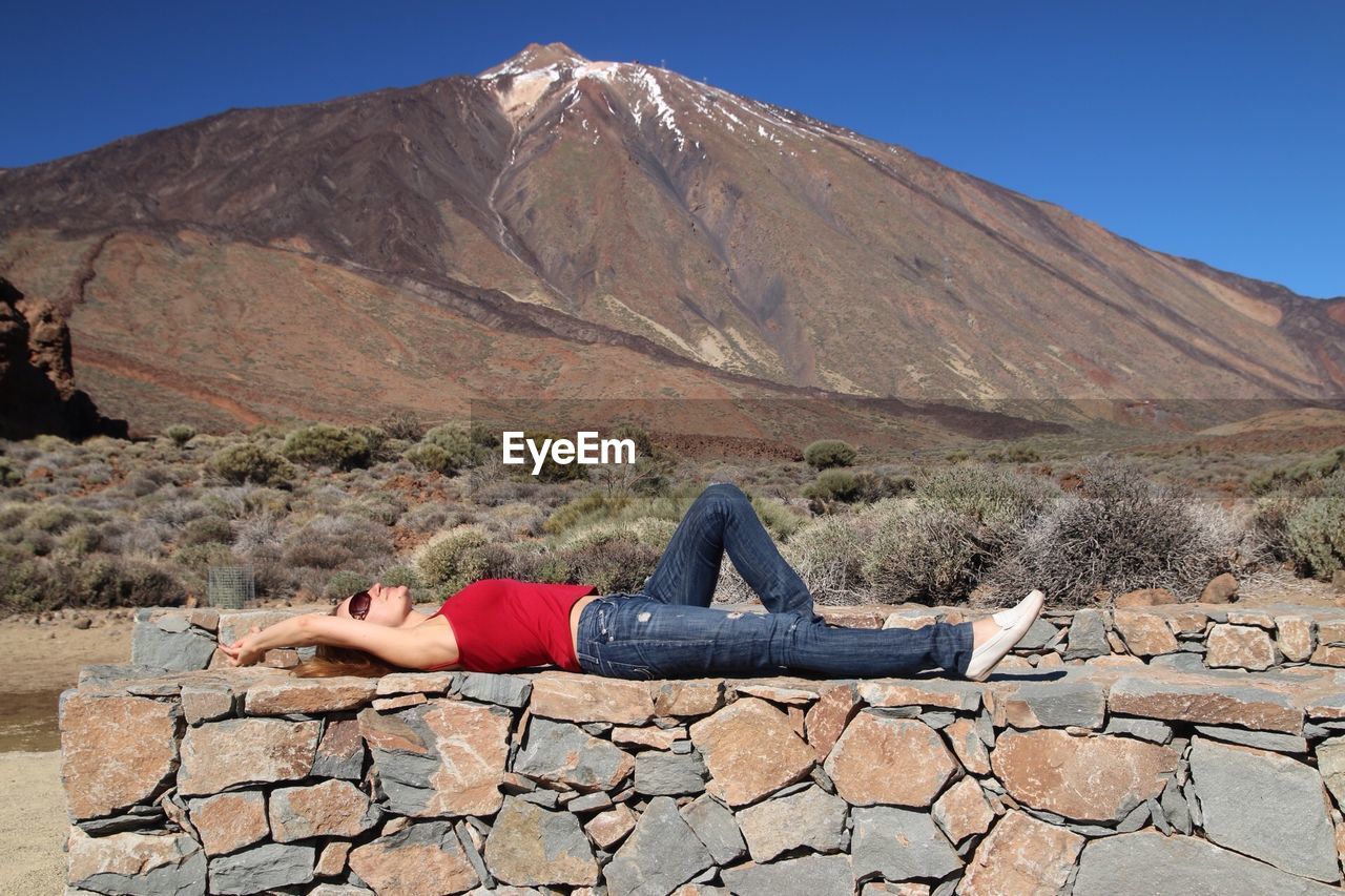 Woman lying down outdoors