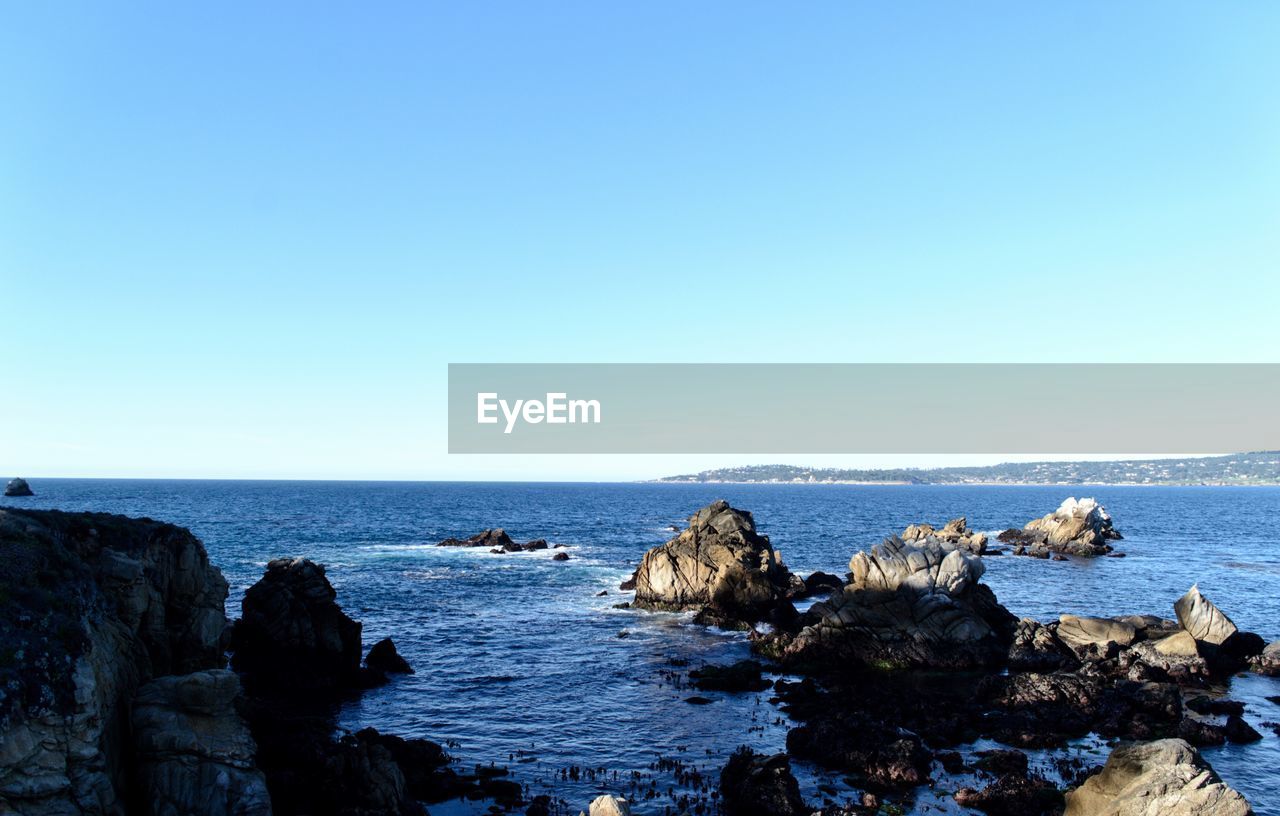 Scenic view of sea against clear blue sky