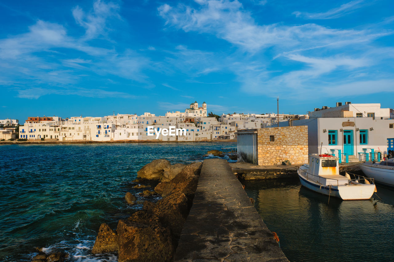 BUILDINGS BY SEA AGAINST SKY