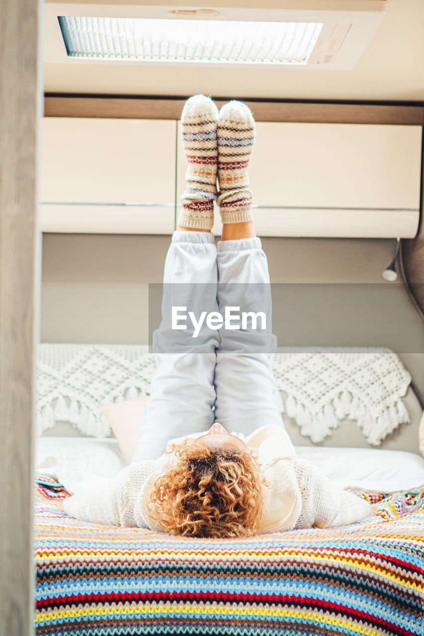 rear view of woman sitting on sofa at home