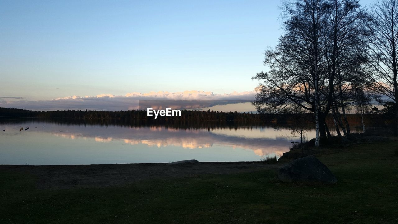 SCENIC VIEW OF LAKE BY TREES AGAINST SKY