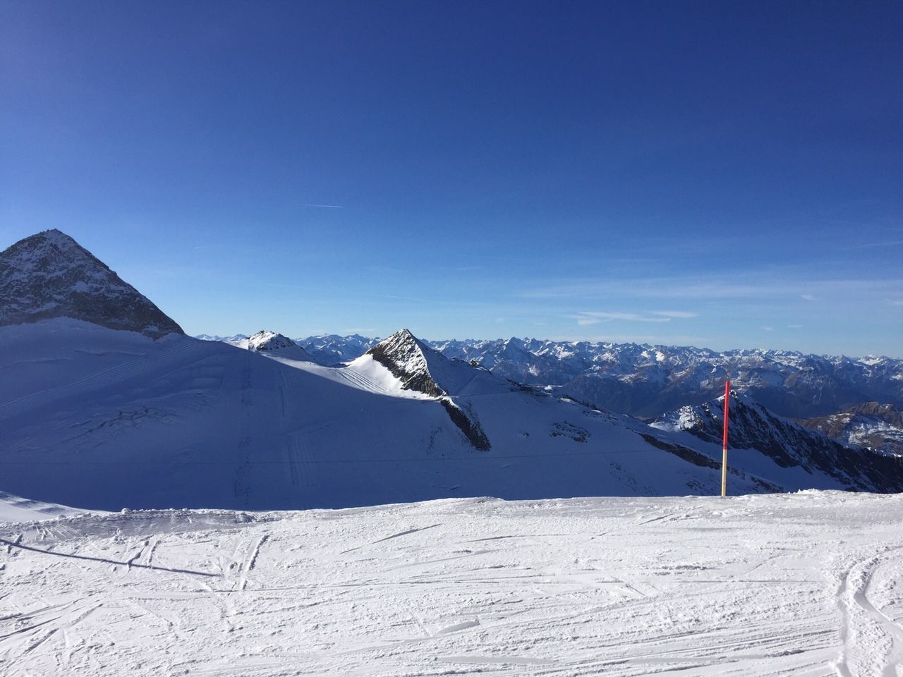 Snow covered mountain against clear blue sky