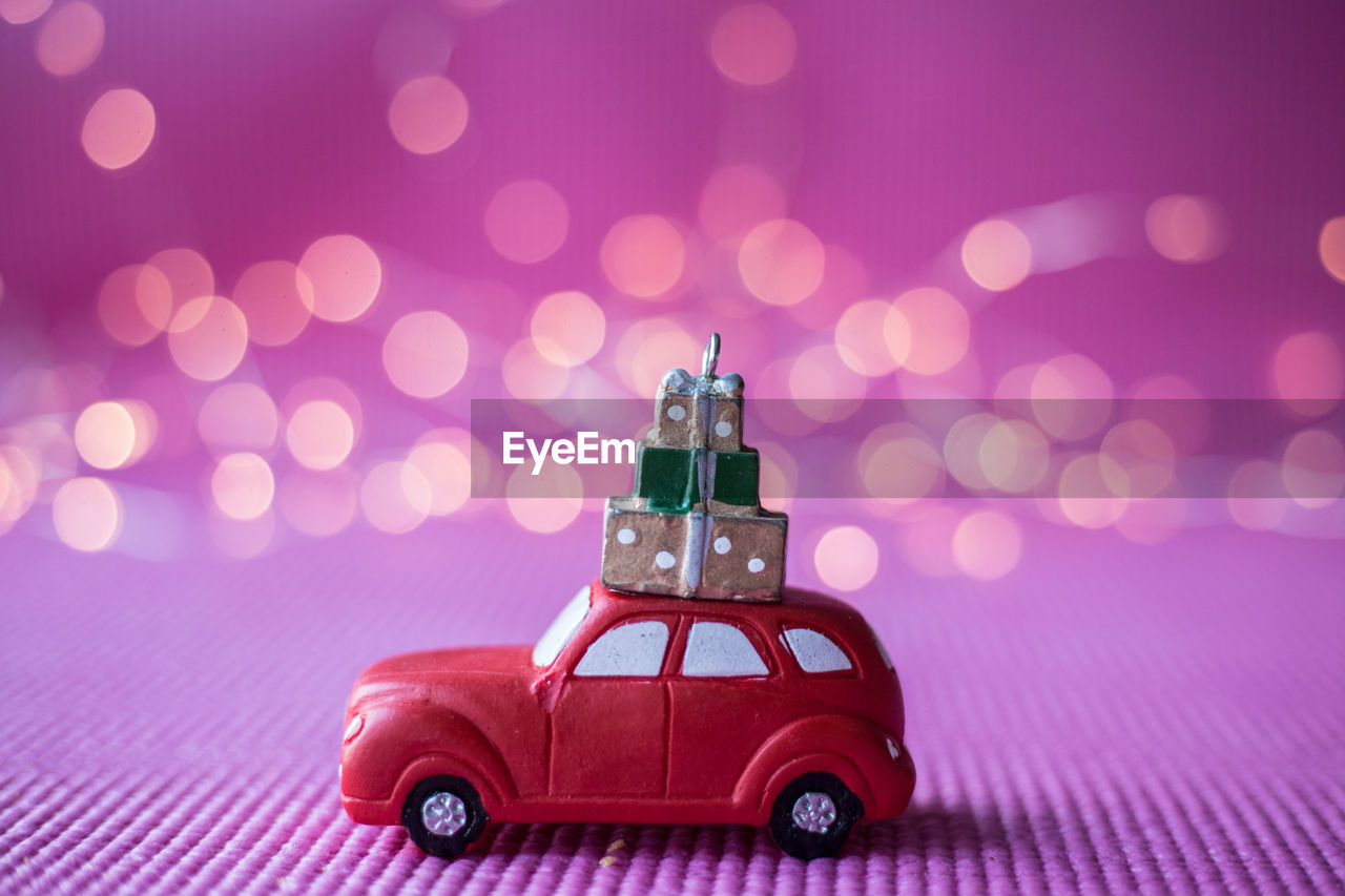 Close-up of toy car on purple fabric