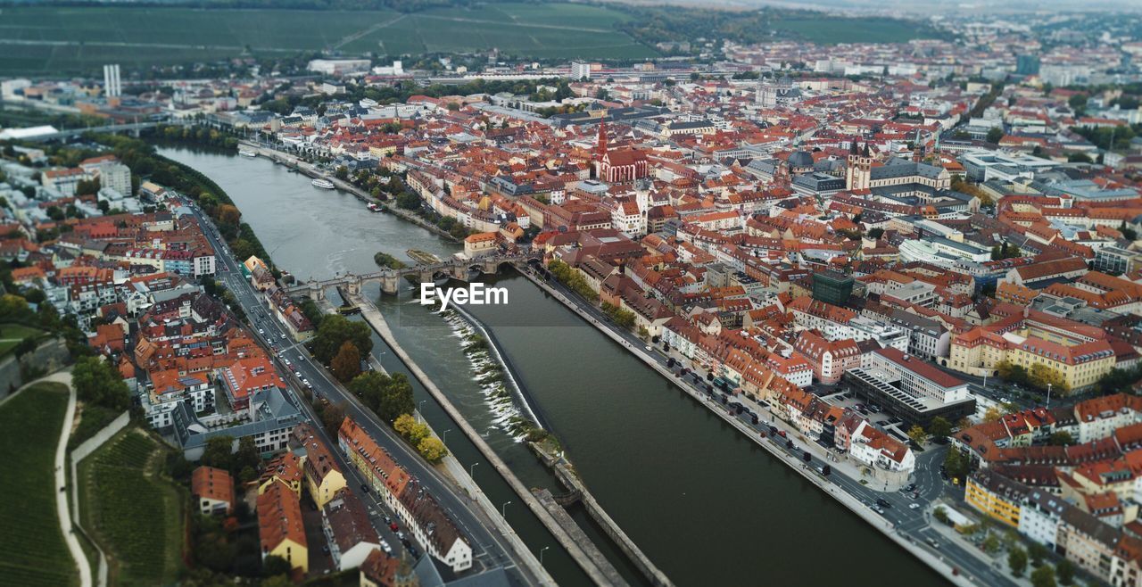 HIGH ANGLE VIEW OF CITYSCAPE AND RIVER