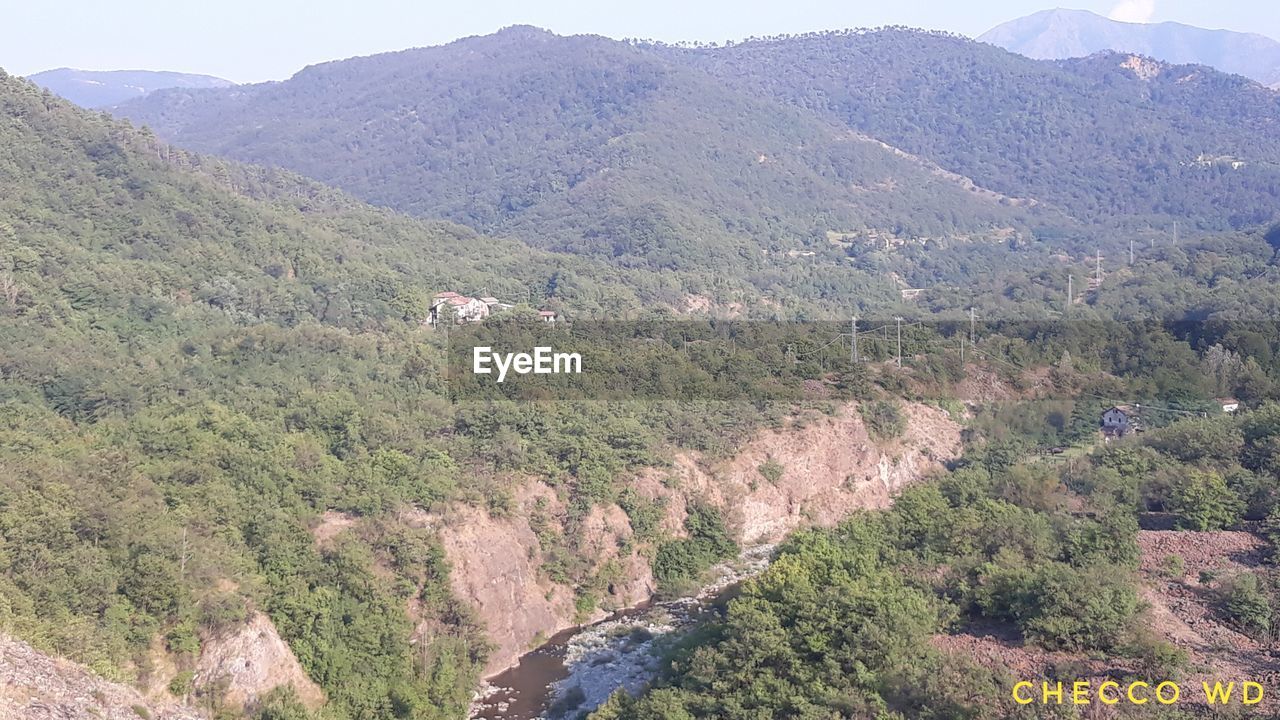 HIGH ANGLE VIEW OF TREES AND MOUNTAINS AGAINST SKY