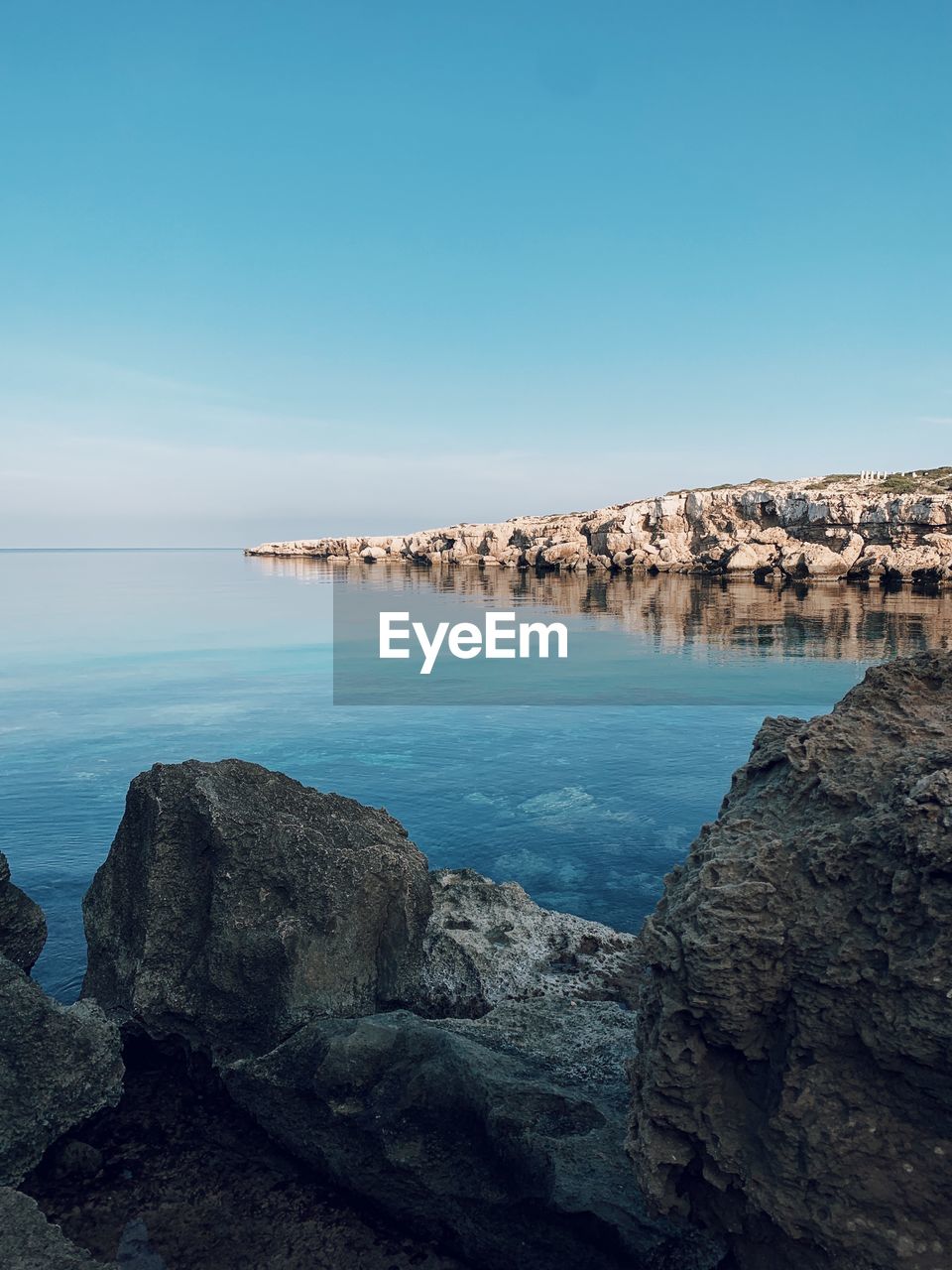 Scenic view of sea against clear blue sky