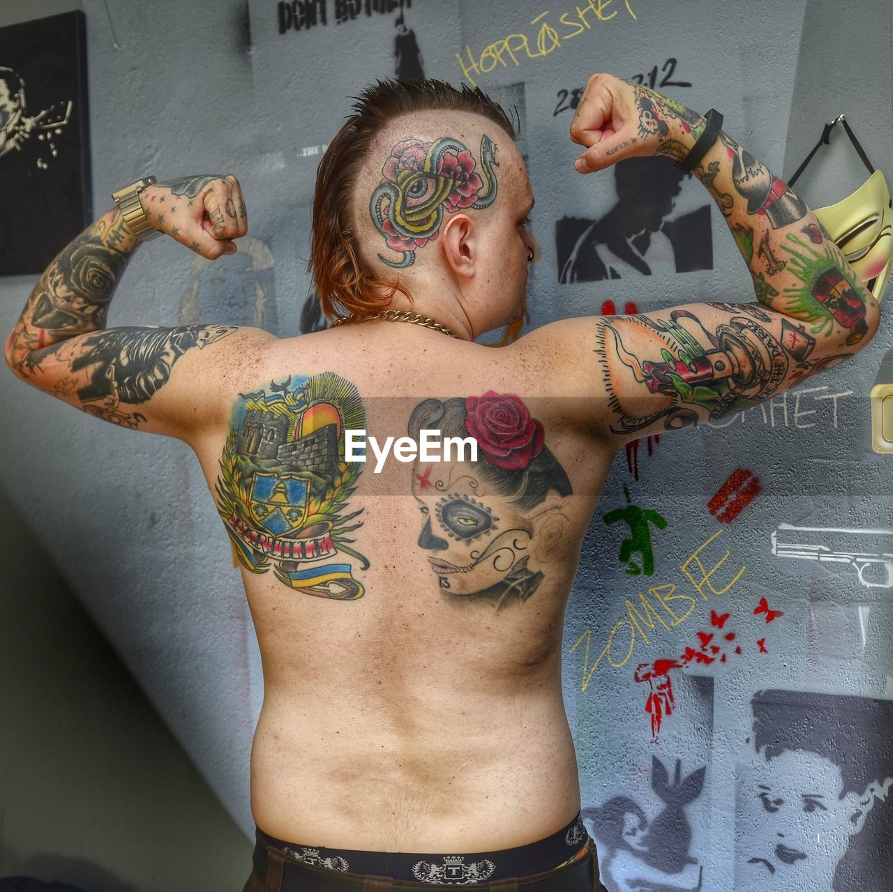 WOMAN STANDING IN FRONT OF WALL