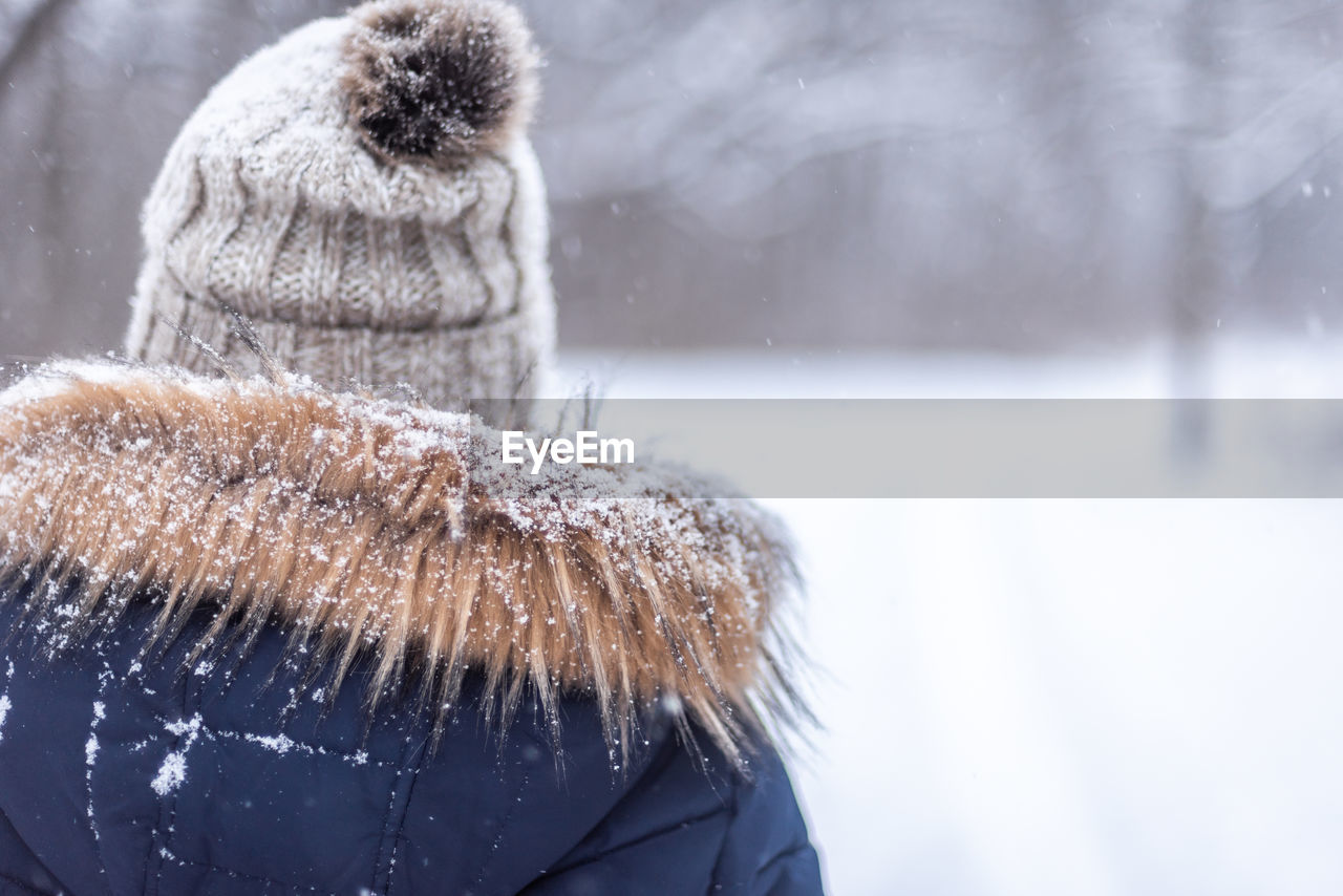 Rear view of woman wearing fur coat during winter