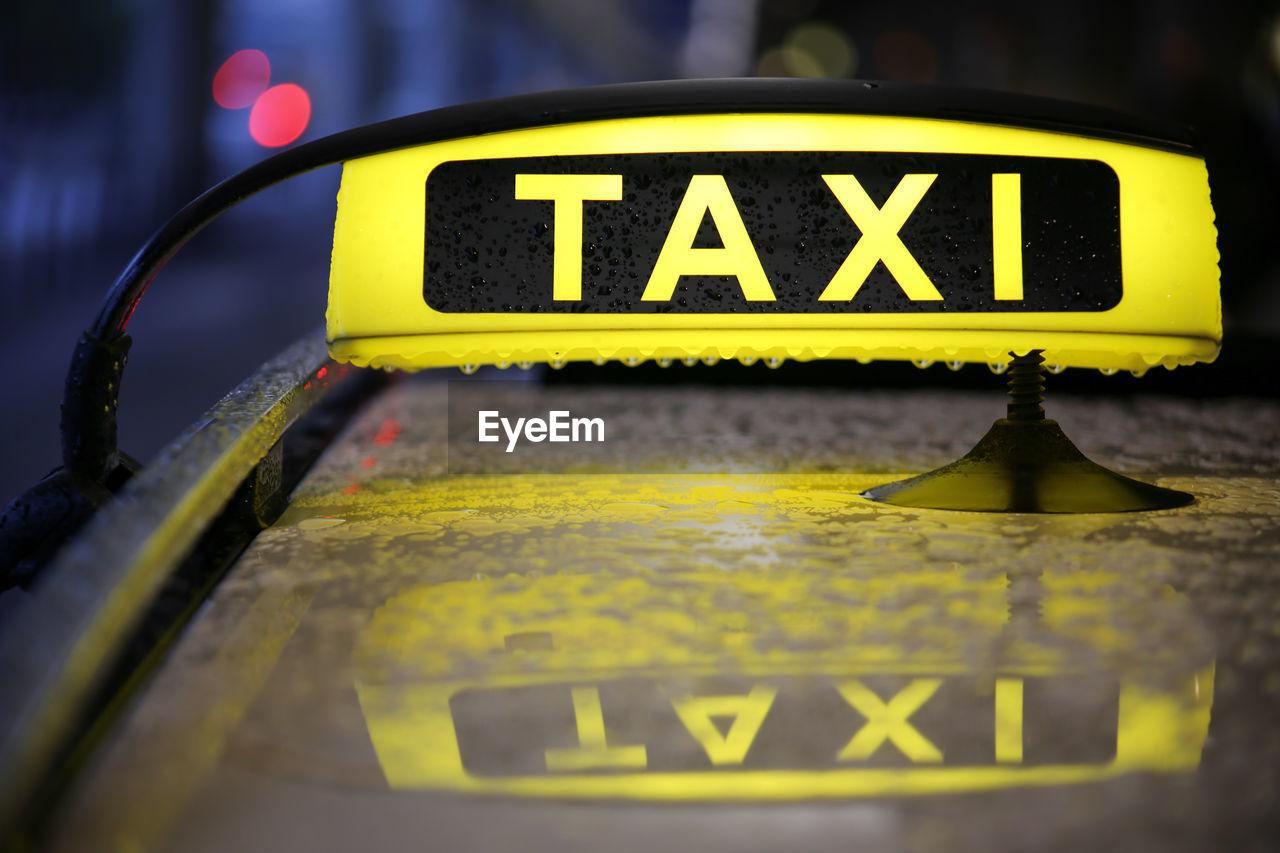 Close-up of yellow sign on car