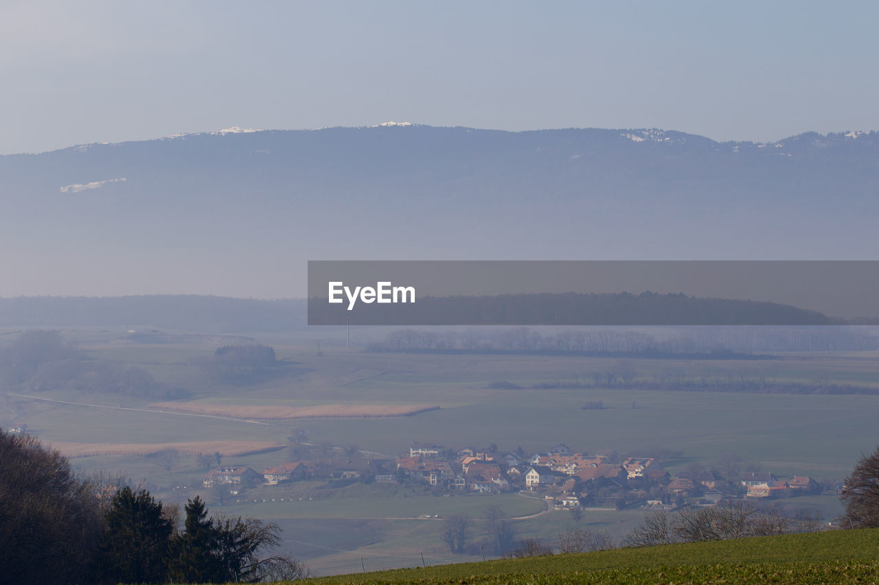 SCENIC VIEW OF LANDSCAPE AGAINST SKY DURING FOGGY WEATHER