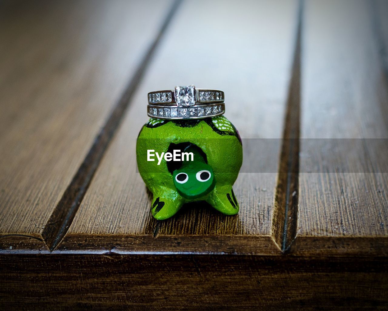 Close-up of rings and toy on wooden table