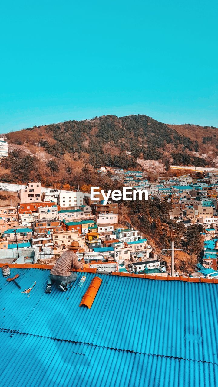 High angle view of man working on roof