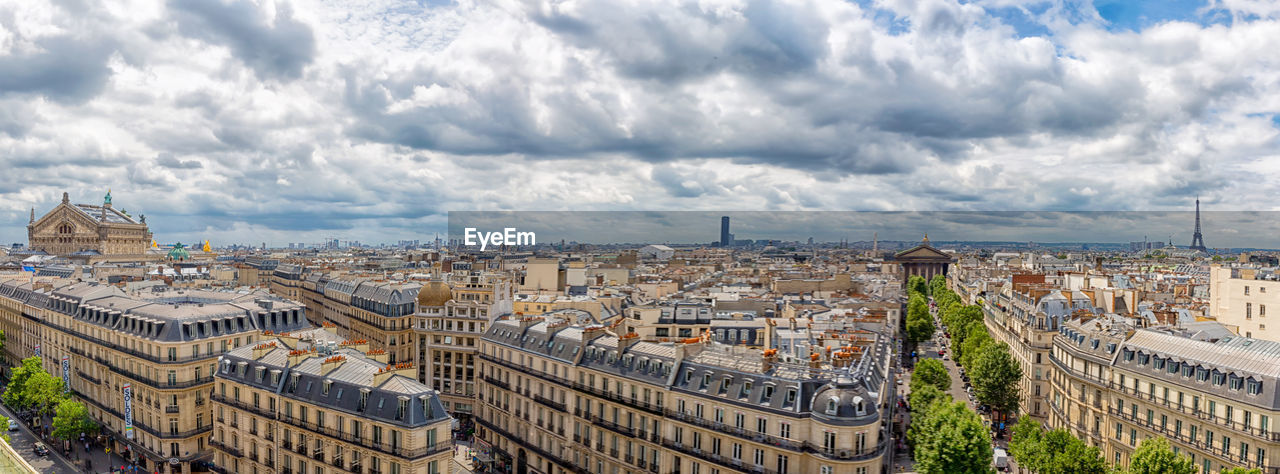 Panoramic high angle view of buildings against cloudy sky