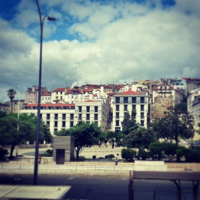 VIEW OF BUILDINGS AGAINST CLOUDY SKY