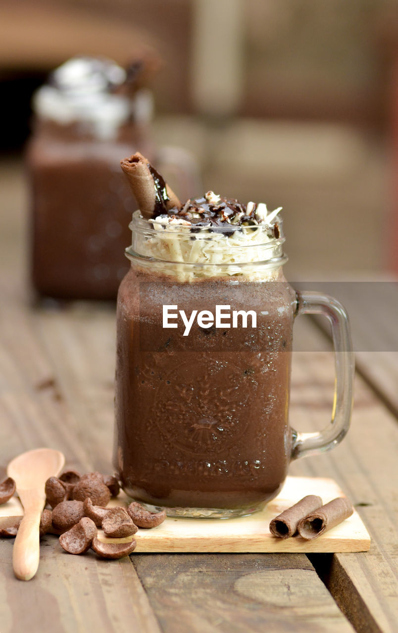 Close-up of dessert in jar on table