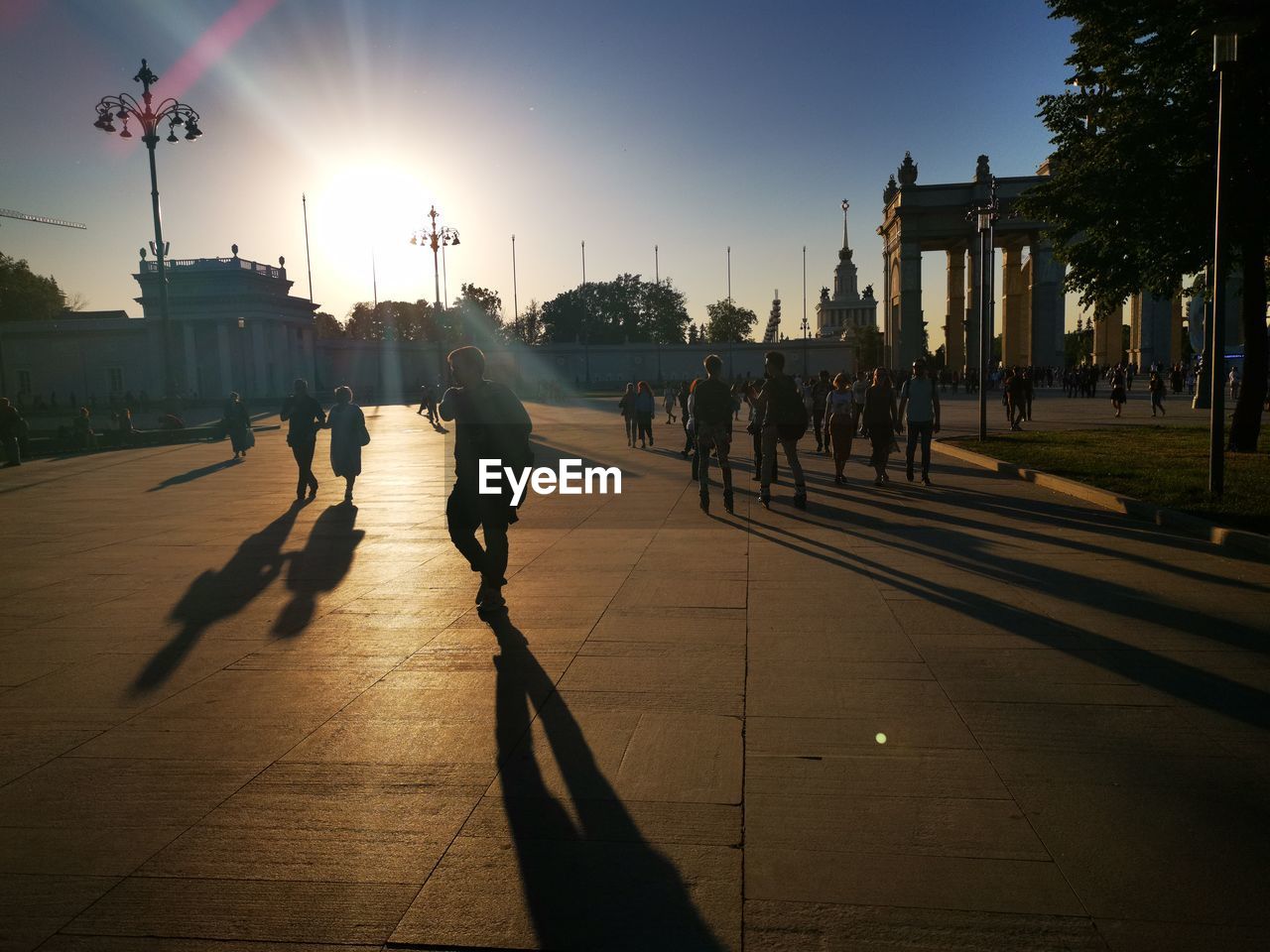 GROUP OF PEOPLE WALKING ON STREET IN CITY