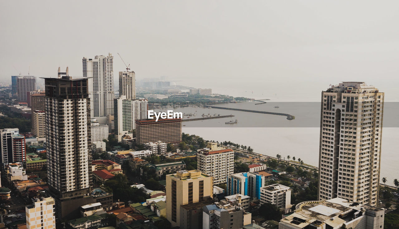 HIGH ANGLE VIEW OF MODERN BUILDINGS AGAINST SKY