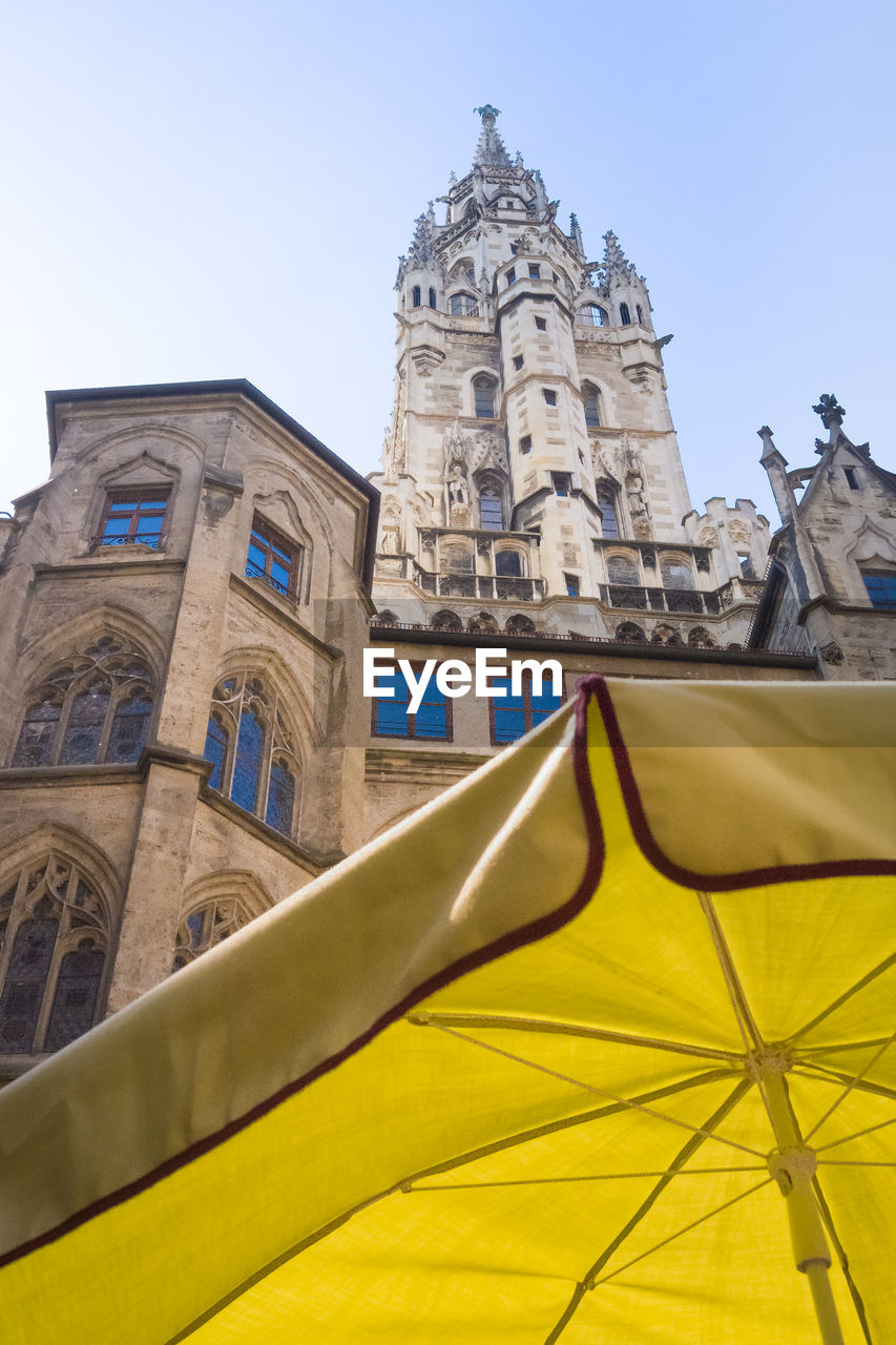 Low angle view of a building with yellow parasol