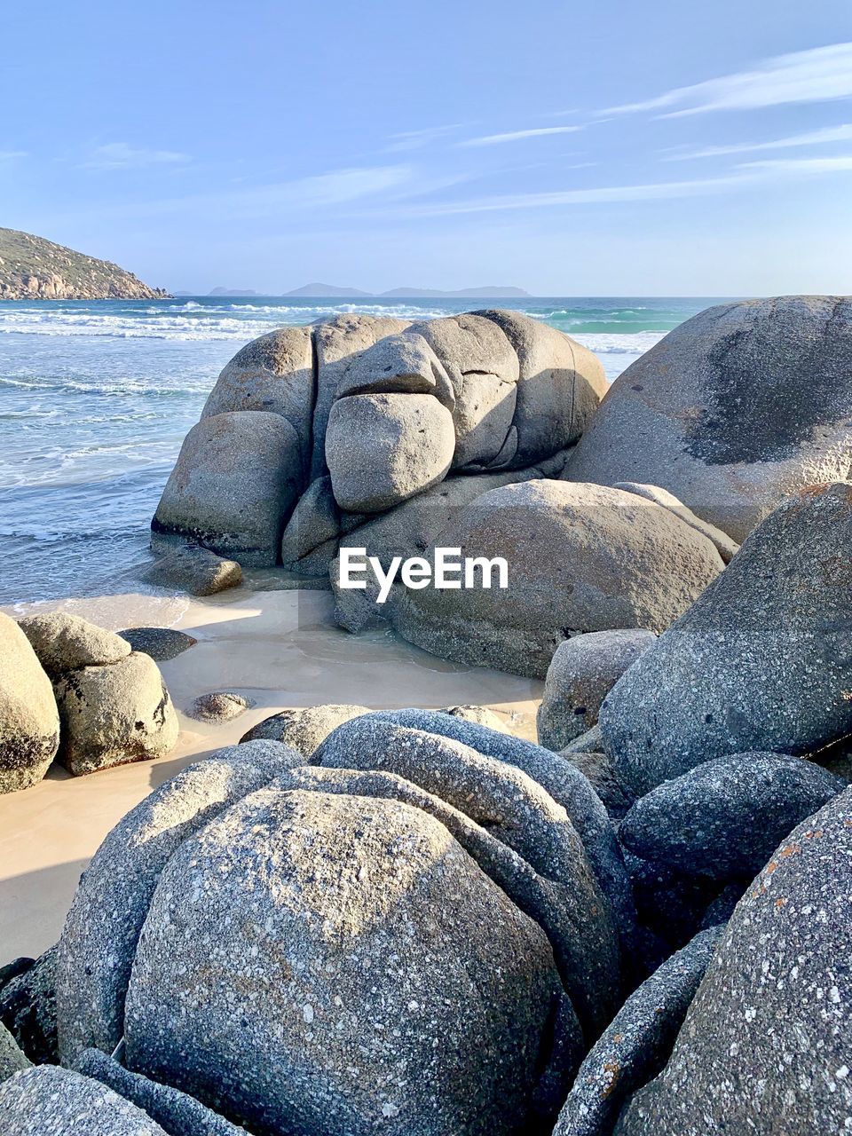 Rocks on beach against sky