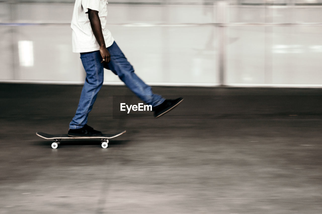 Low section of man skateboarding in park