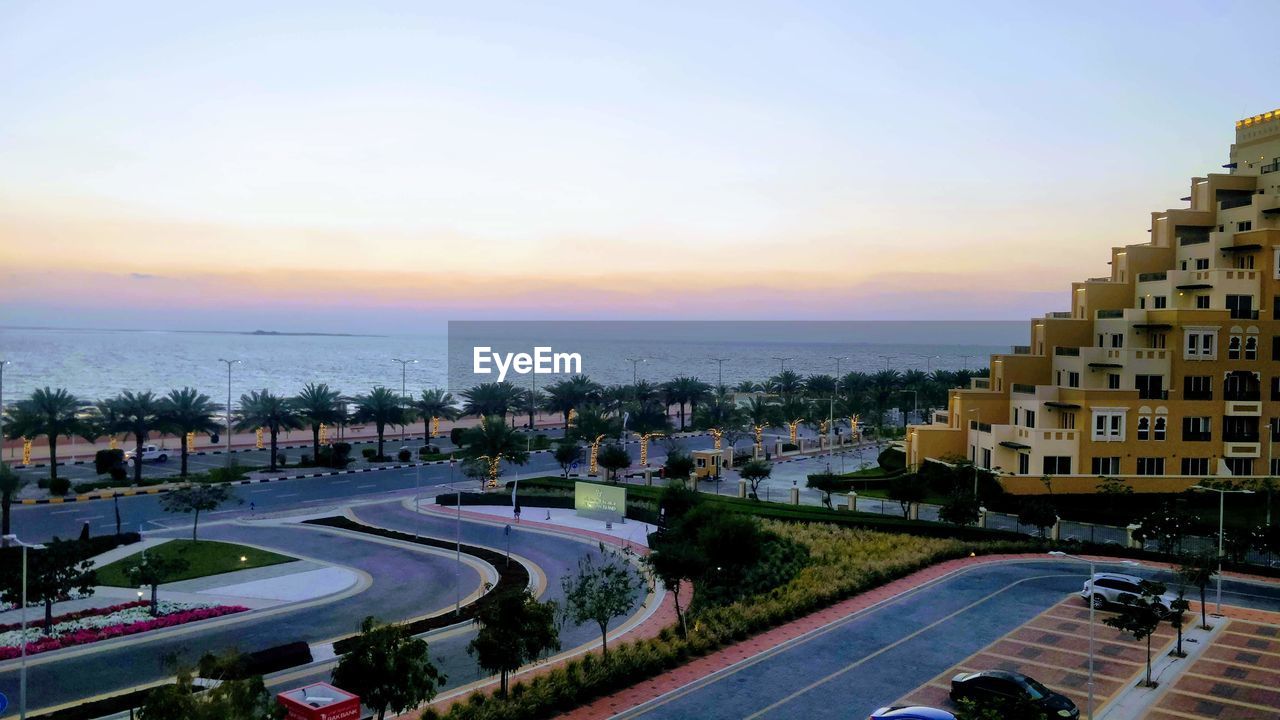 HIGH ANGLE VIEW OF ROAD AGAINST SKY AT SUNSET