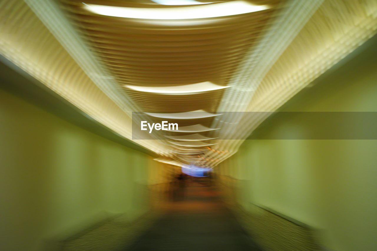 BLURRED MOTION OF ILLUMINATED CEILING IN BUILDING