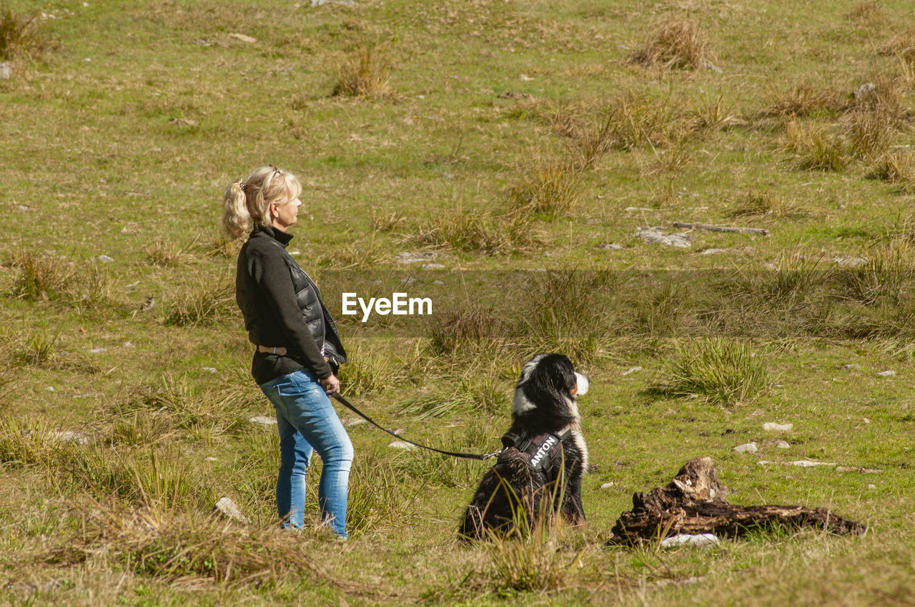 Full length of man with dog on grass