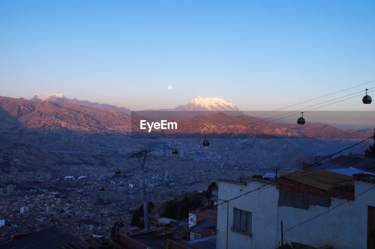 SCENIC VIEW OF TOWN AGAINST SKY DURING WINTER