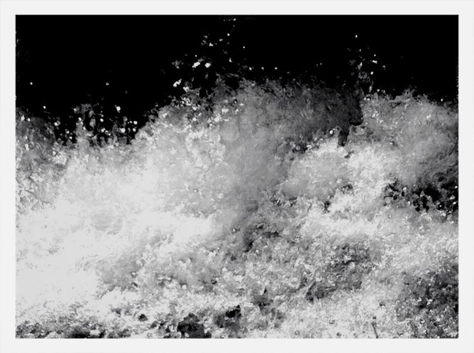 BLURRED MOTION OF WATER SPLASHING ON THE BEACH