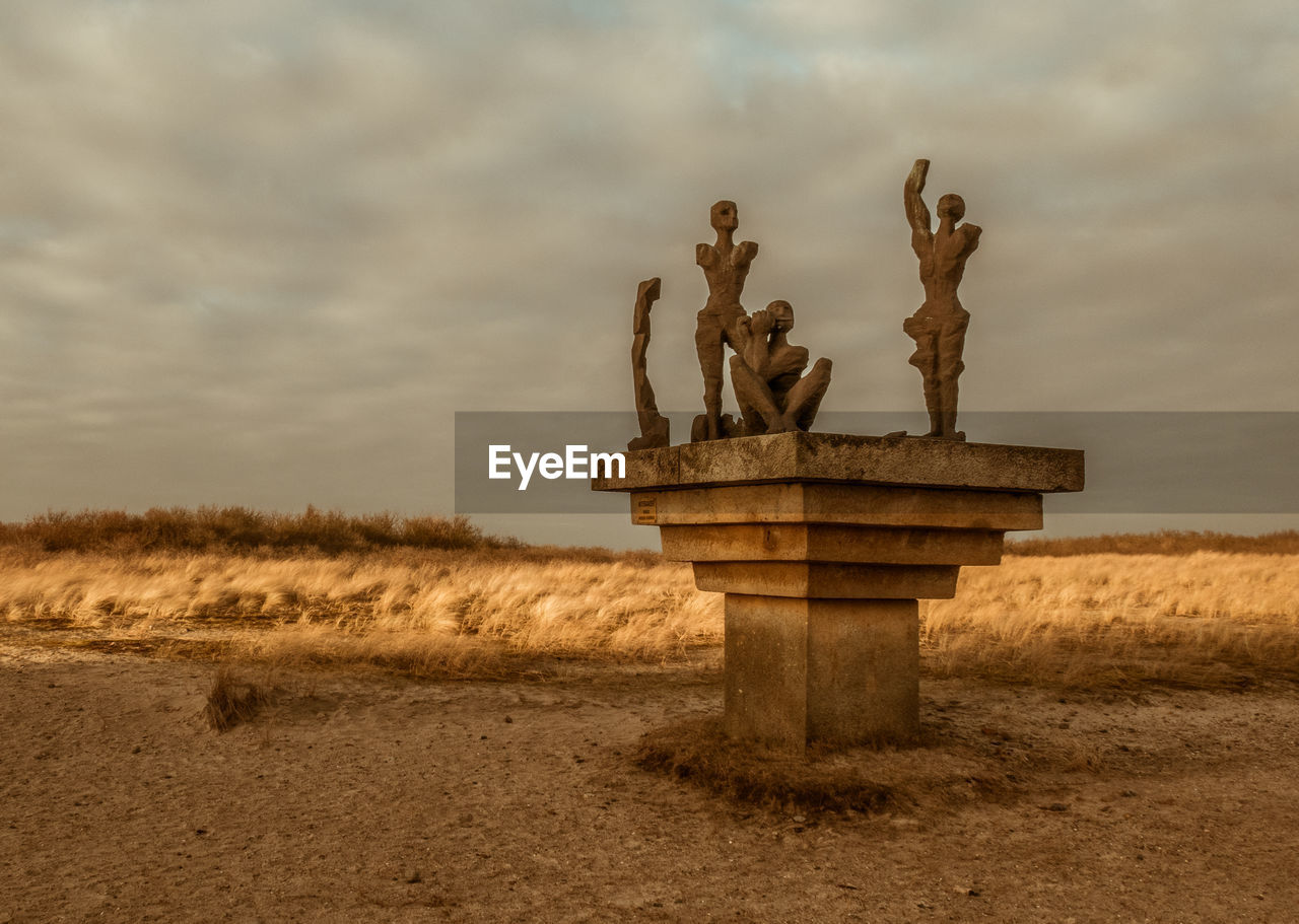 Statues against sky
