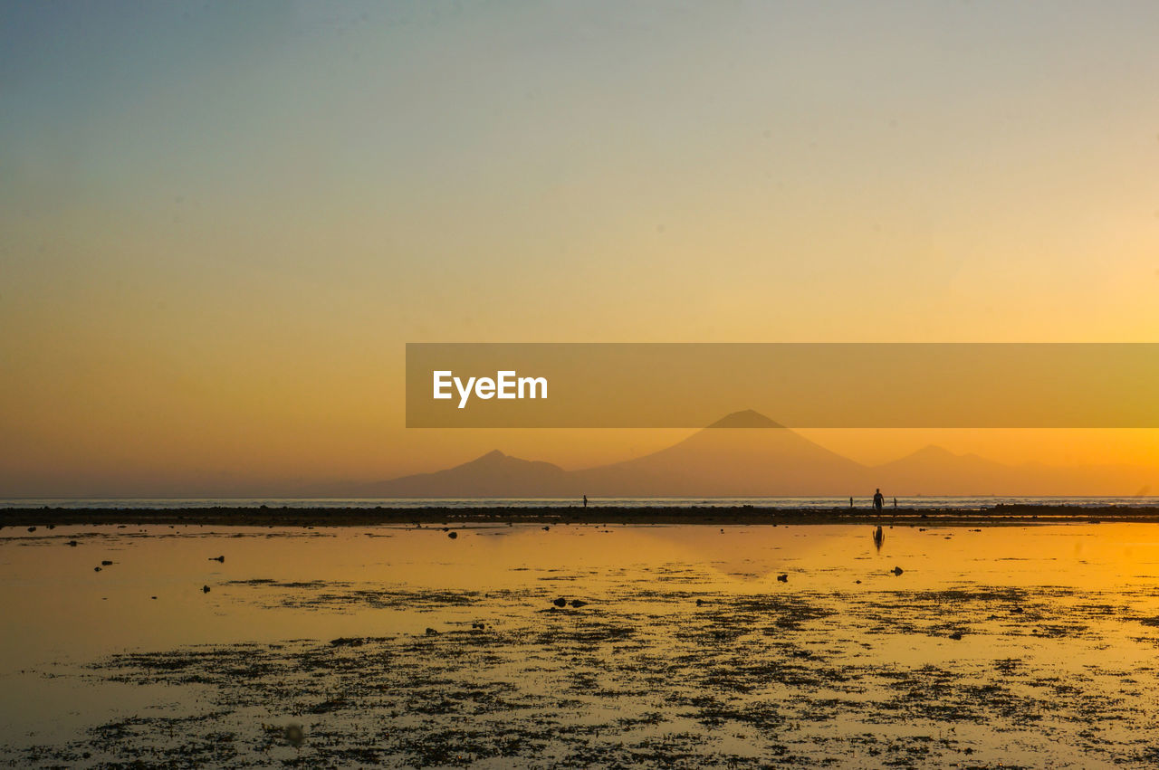 Scenic view of sea against orange sky