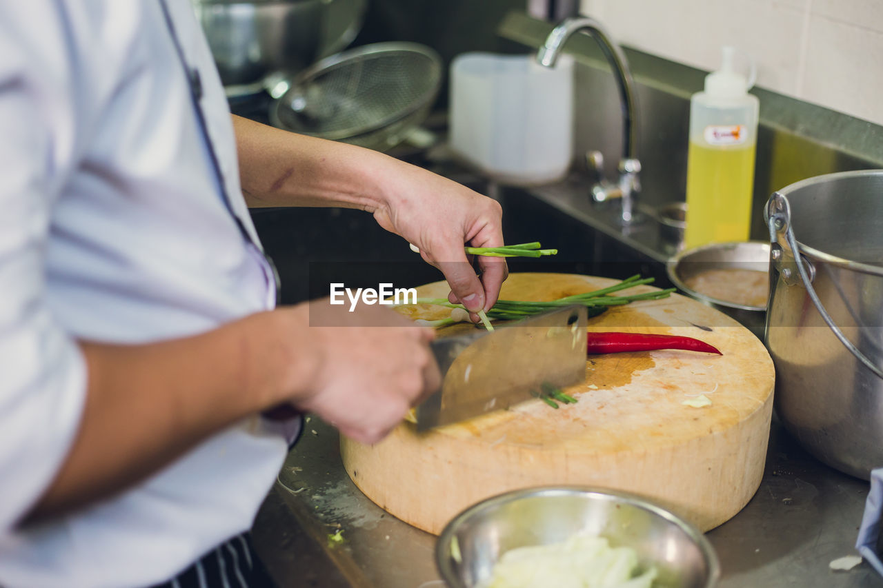 Close-up of man preparing food in kitchen