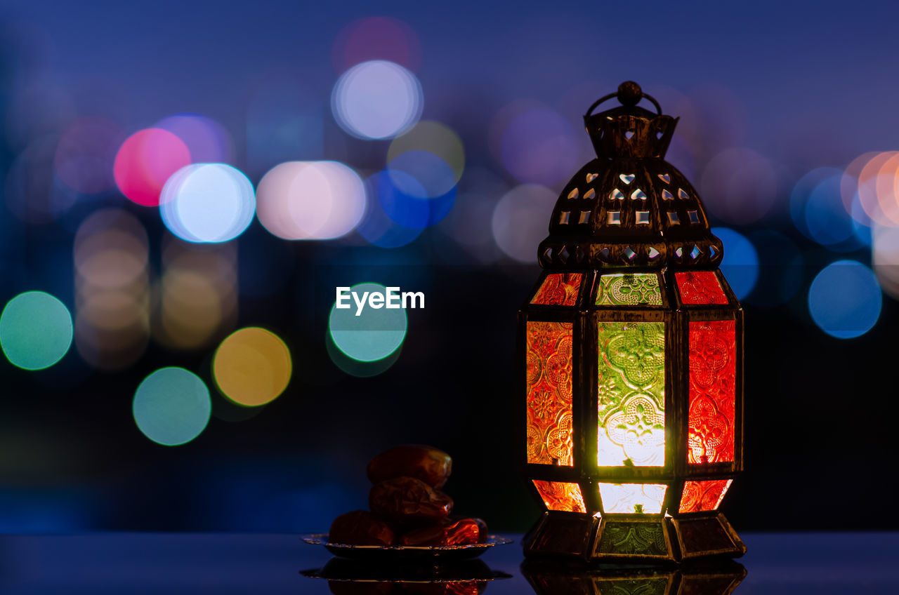 Lantern and small plate of dates fruit for the muslim feast of the holy month of ramadan kareem.