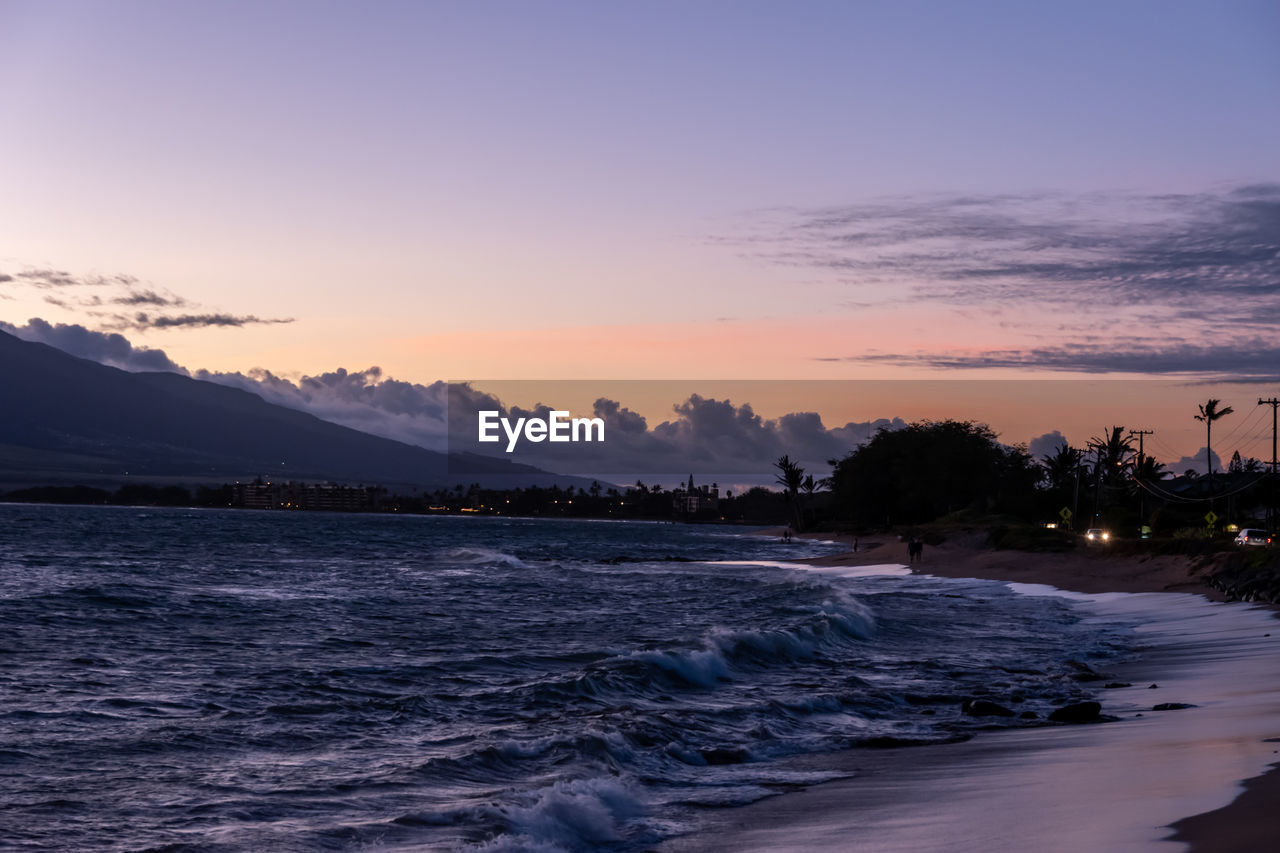 SCENIC VIEW OF BEACH DURING SUNSET