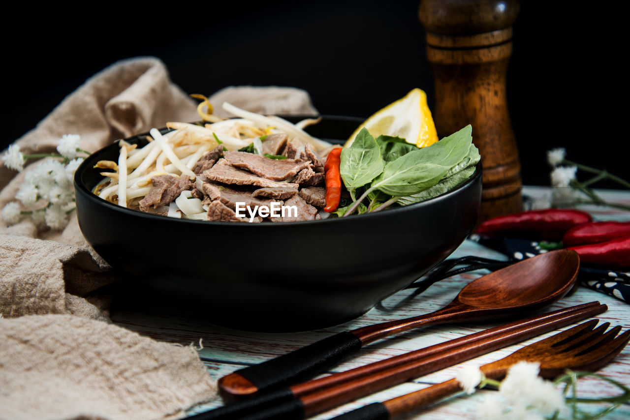 Close-up of food on table against black background