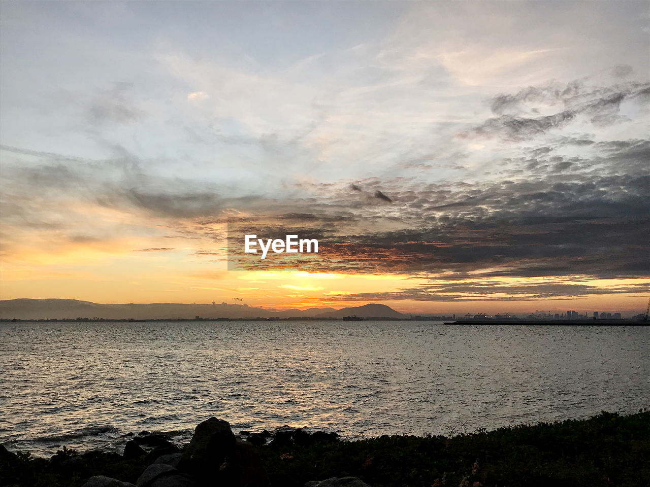 SCENIC VIEW OF SEA AGAINST ORANGE SKY